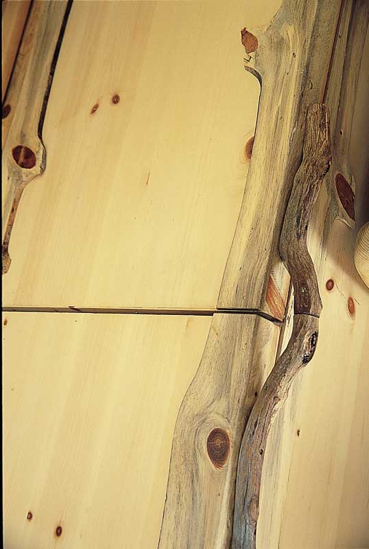During his sojourns in the woods, Tom gathered tree roots misshapen by growing through rock cracks. This collection turned out to be the perfect hardware for the couple’s cabinets—another tribute to the land that adds texture and depth to their home. Tom had a picture in his mind of exactly the twig he wanted to use as a handle for the refrigerator—and when he took a walk in the woods near the house, nature delivered. To make the handles, Tom trimmed the edges to make them flat, then glued the roots into place on the doors. When replacing a refrigerator handle, you must utilize the same screw holes for the new handle as used for the old. Otherwise, you will create holes in the insulation of the refrigerator door that make it less efficient.